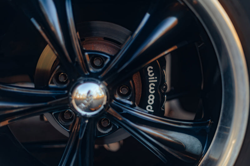 Wilwood brake caliper behind the wheel